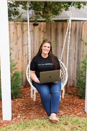 A lady with a laptop on her lap.